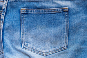 Blue denim jeans back pocket close up